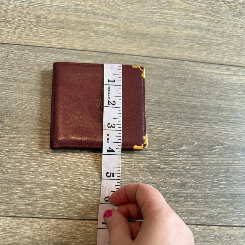 Cartier Men’s Deep Red Leather Bifold with Gold Corners